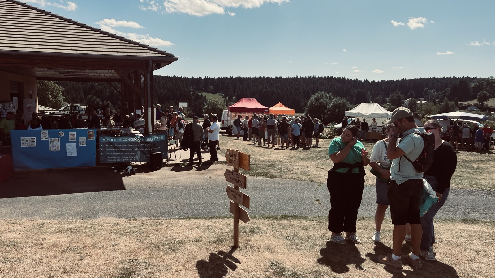 Vue large de la fête, public et stands